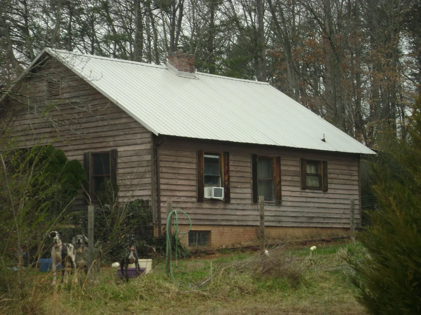 White metal roof on an old wood sided farmhouse, from a Metal Roof Installation job in Verndale
